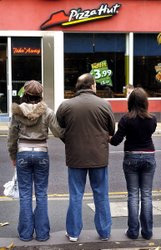 Paul Wrightson and his two daughters outside the Pizza Hut restaurant in Bingley